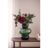 Stilkblomst Peon og gren eucalyptus i grønn vase