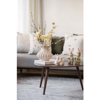 Harer i strå stående på sofabord som påskepynt