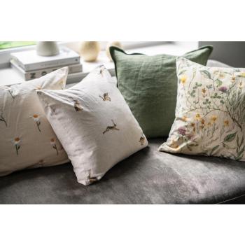 Sofakrok pyntet med linputer, velurputer med blomstermotiv